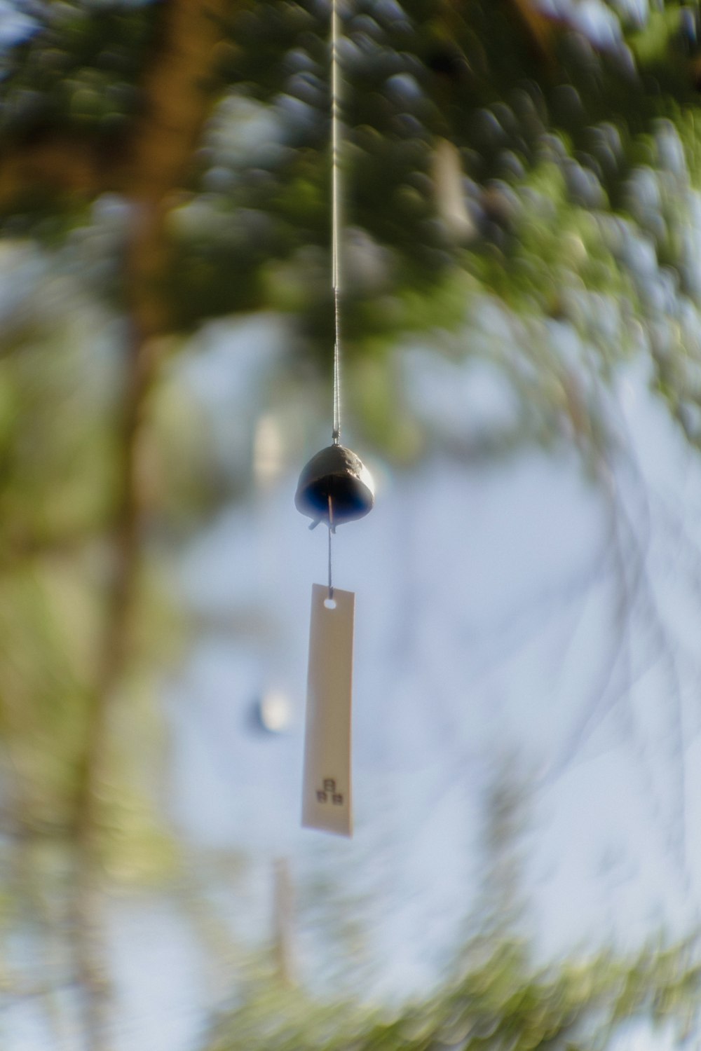 a wind chime hanging from a tree