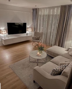 A cozy living room featuring elegant curtains and a stylish TV unit from modrenhome design.