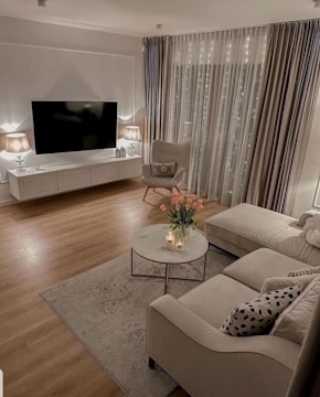 Cozy 1 BHK living room with warm lighting and modern furniture.