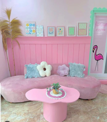 Soft pastel pink treatment room with delicate lavender accents and floral textures.