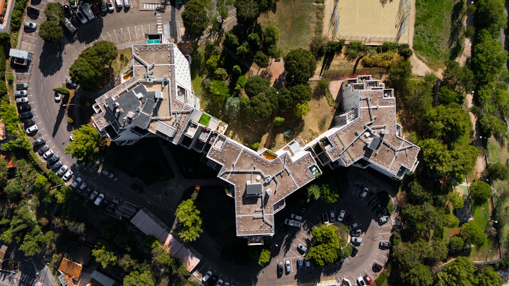 an aerial view of a building in the middle of a park