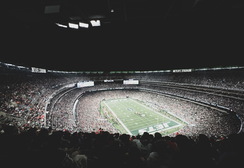 a stadium filled with lots of people watching a football game