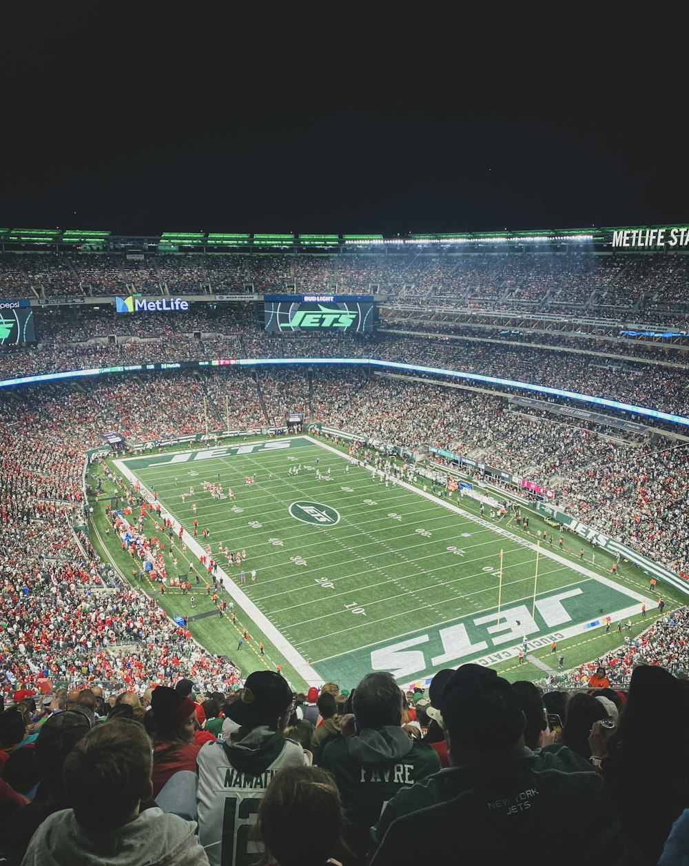 a stadium full of people watching a football game