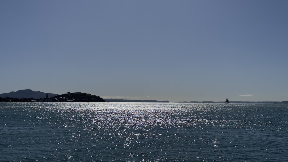 a large body of water with a small island in the distance