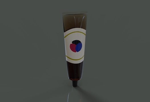 A brown tube, likely cosmetic or medicinal, standing upright against a dark green background. The tube has a label featuring a simple design with a red and blue graphic.