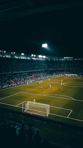 A vibrant soccer match in progress under stadium lights, capturing the energy of local leagues.