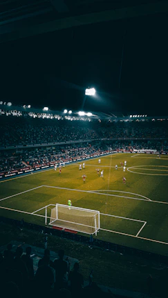 High-energy soccer match at Arena Vibe with players in action under bright lights.