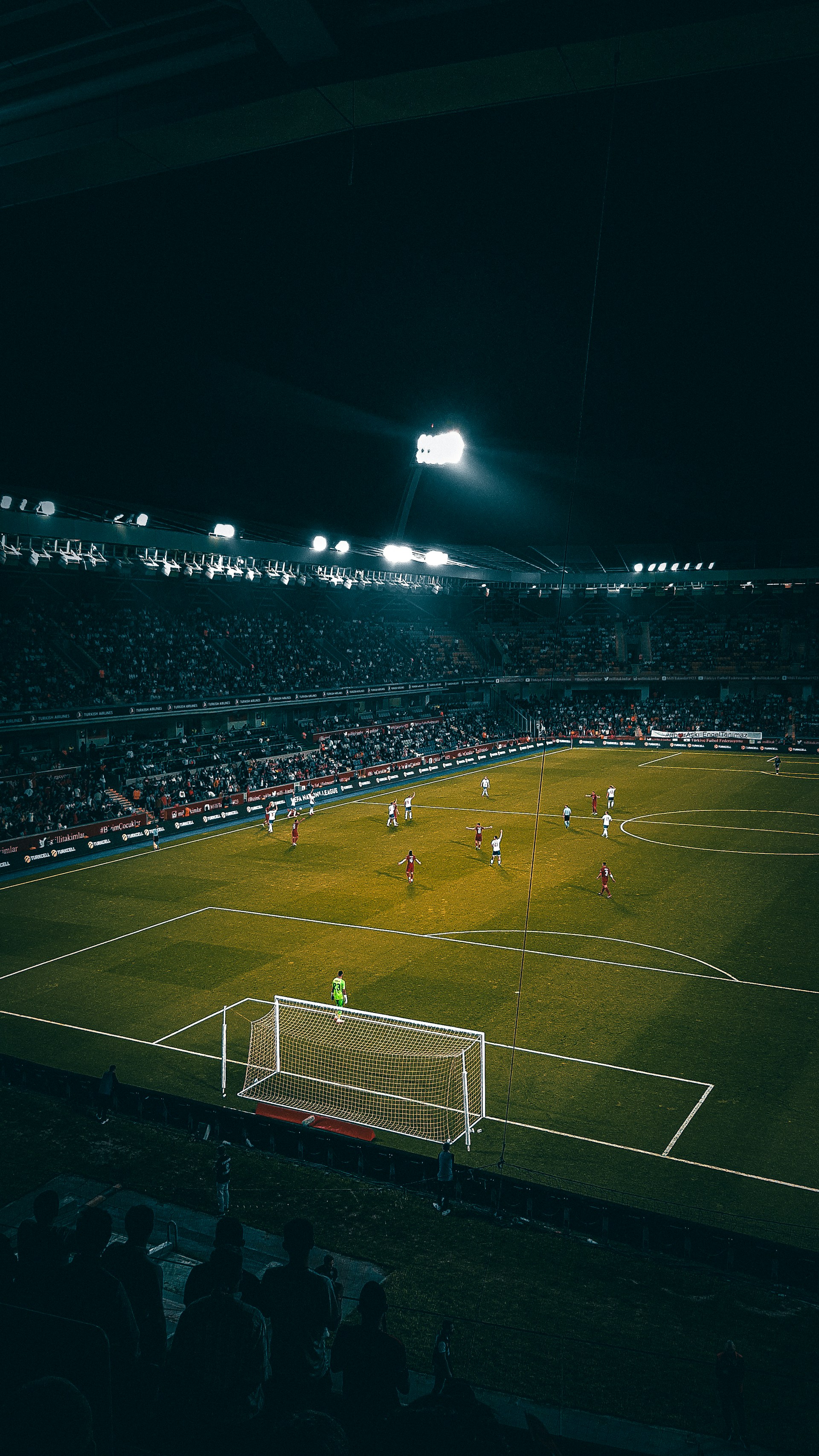 A thrilling moment of a player scoring a goal under bright stadium lights, capturing the intensity of Liga Mastergol.