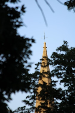 A serene church steeple silhouetted against a clear blue sky in Troy, Michigan.