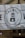 A banner displaying a logo with the text 'THE WELL' and an image of a water well with a droplet. The banner indicates the establishment has been serving Sheffield since 2015. It is mounted on a stone building and features decorative light bulbs hanging in front of it.
