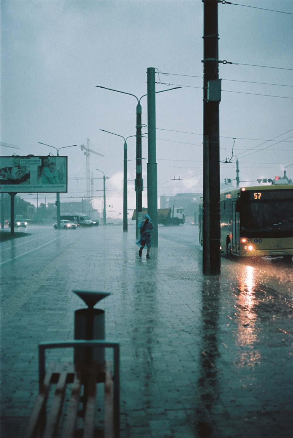 a person walking down a street in the rain