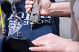 Heat-press machine applying a DTF transfer onto a sportswear fabric