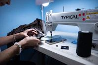 a woman is working on a sewing machine