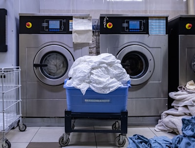 a laundry room with a washing machine and a laundry basket