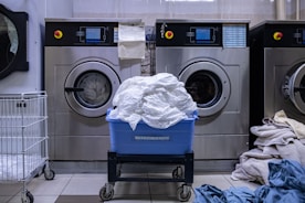 a laundry room with a washing machine and a laundry basket