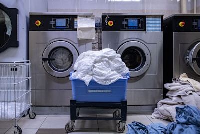 a laundry room with a washing machine and a laundry basket