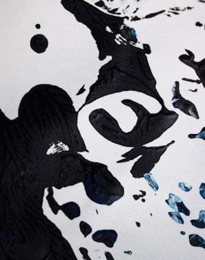 A surreal black ink piece featuring abstract symbols against a warm retro 80s background.