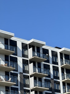 A modern apartment building with glass balconies.