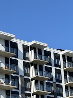 A modern apartment building with glass balconies.