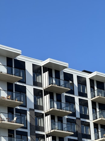 A stylish apartment building facade with balconies overlooking the city.