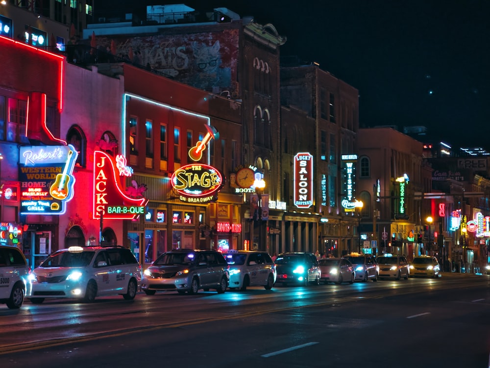 a city street filled with lots of traffic at night