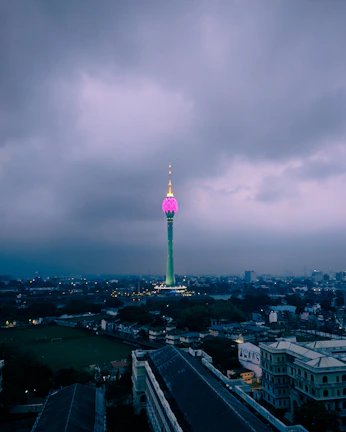 Wide view of an urban wireless hotspot tower glowing at dusk.