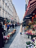 A charming street in Bishop Auckland lined with historic buildings and colorful shops on a sunny day.