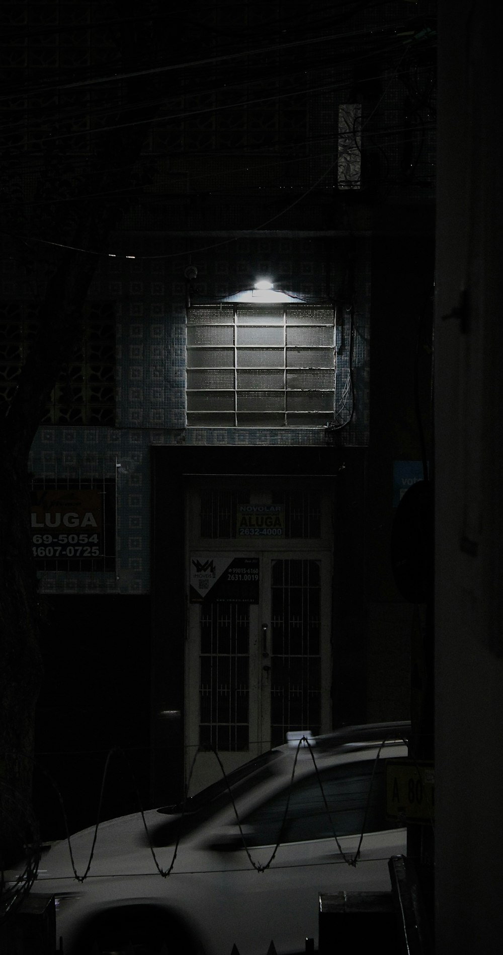 a car parked in front of a building at night