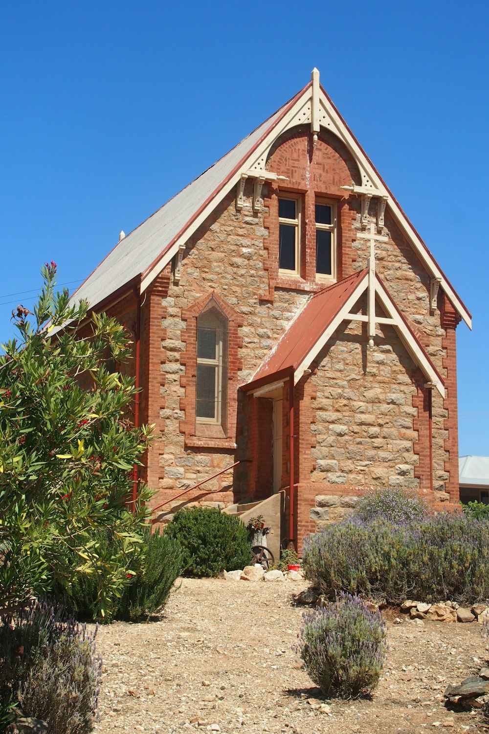 a small church with a steeple and a steeple on the side of it