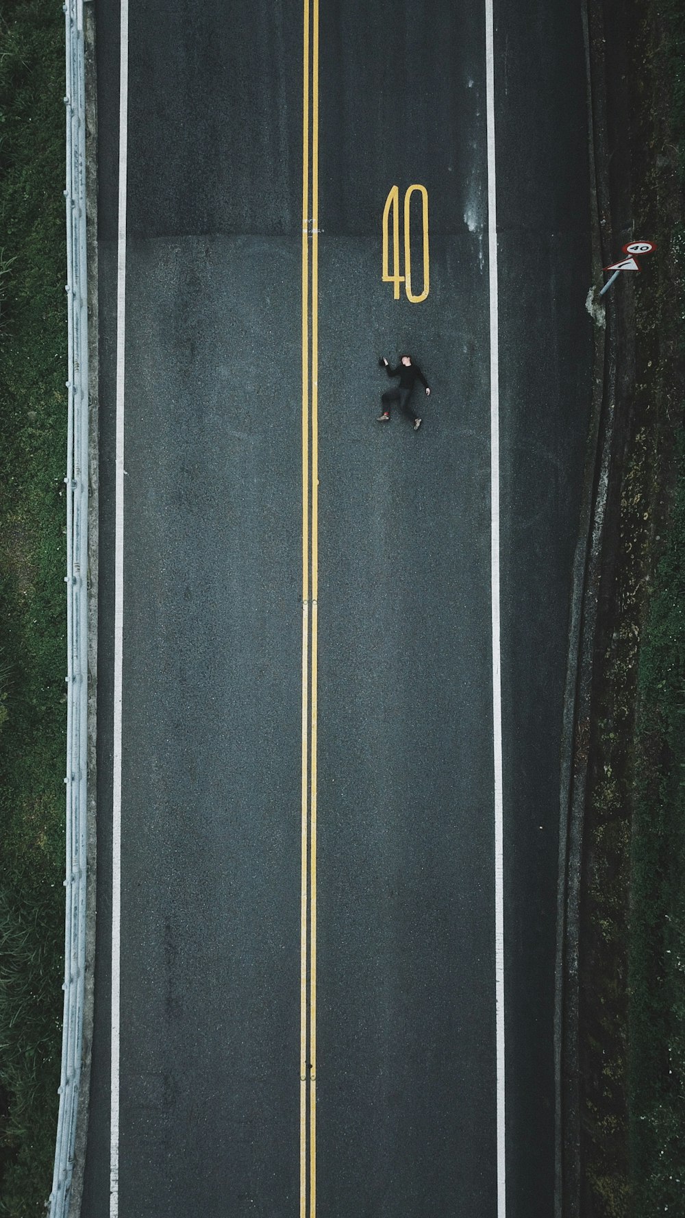 an overhead view of a road with a yellow line