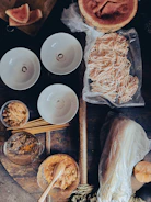 Fresh ingredients laid out on a wooden table ready for a culinary project.