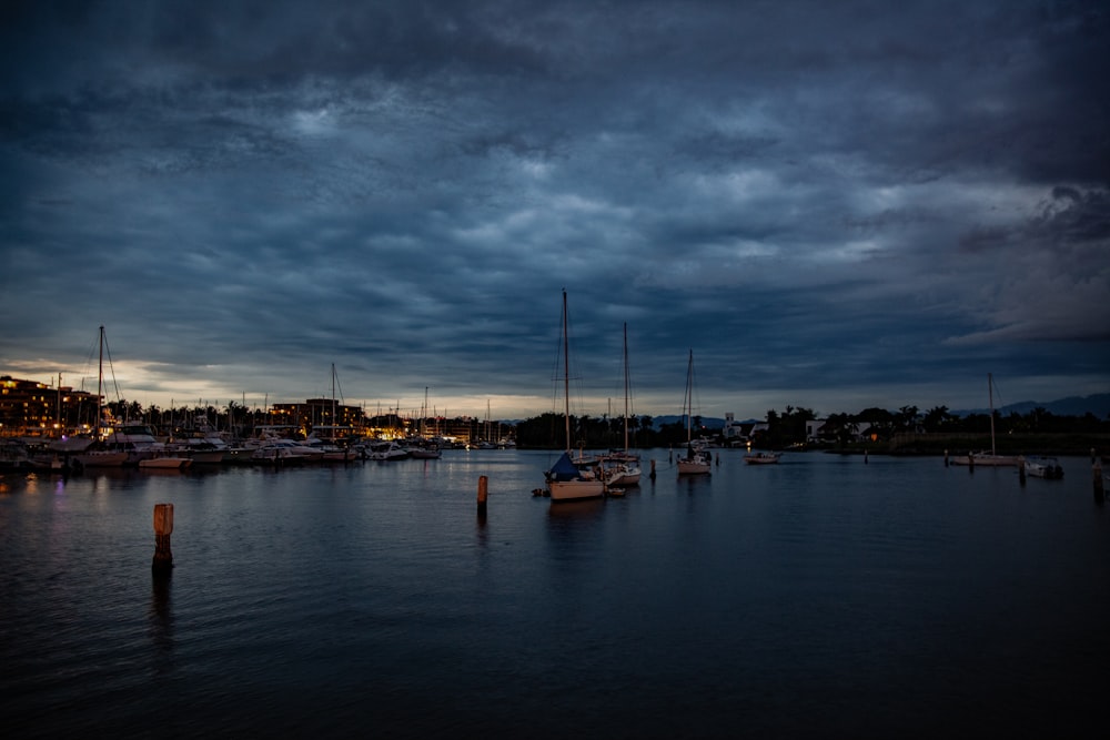 a harbor filled with lots of boats under a cloudy sky