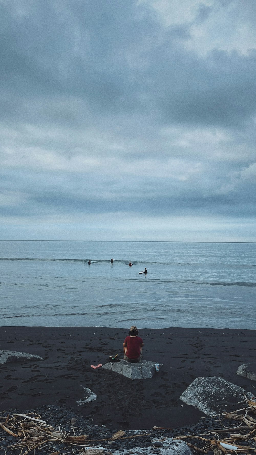 a person sitting on a beach near the ocean