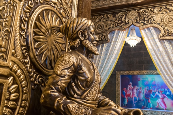 a statue of a man sitting in front of a tv