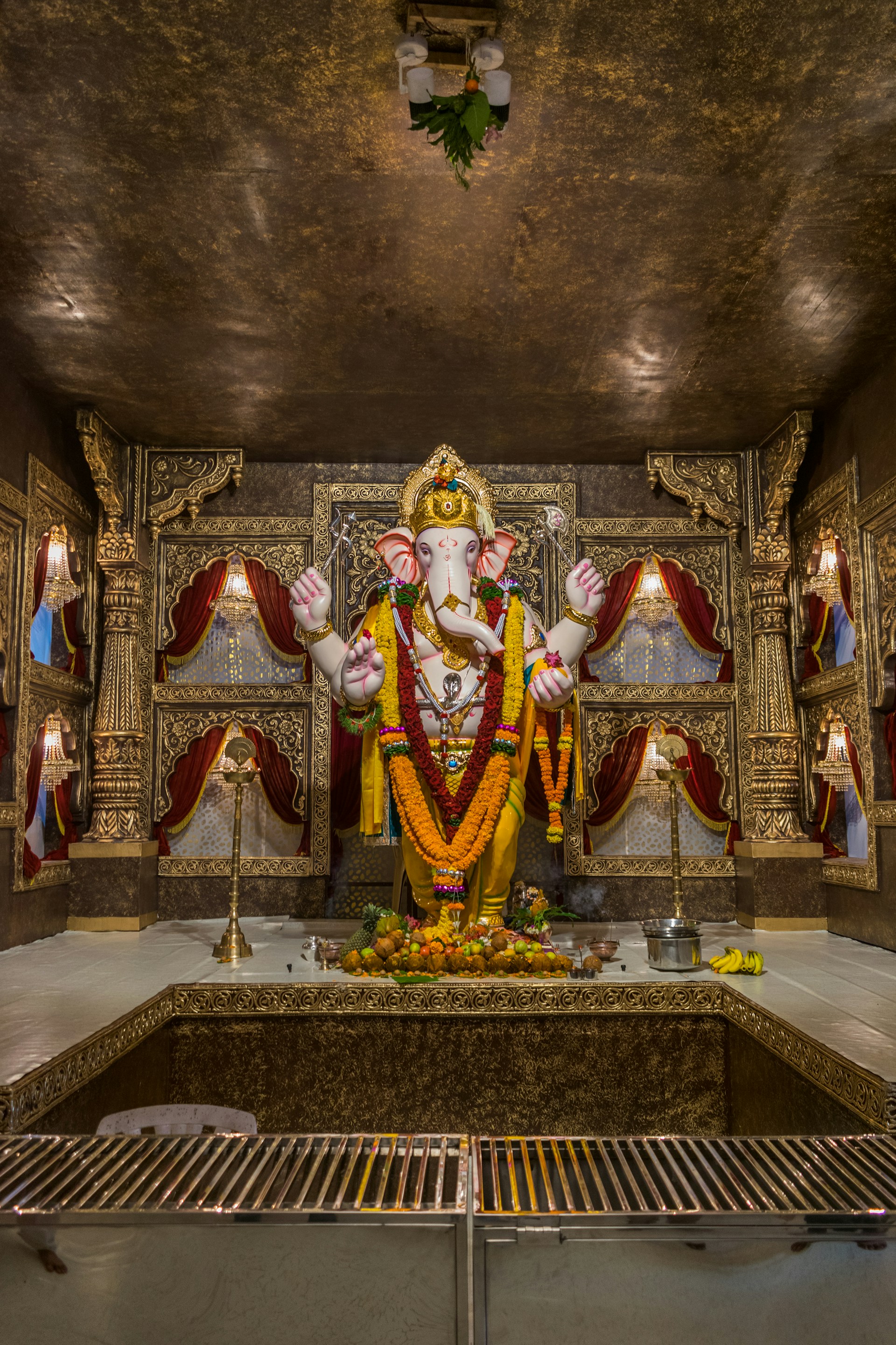 Inner sanctum of Maha Lakshmi Mandir showing the beautifully maintained idol of Goddess Lakshmi with vibrant floral offerings.