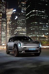 Volvo S90 cruising through Manhattan streets with city lights glowing.