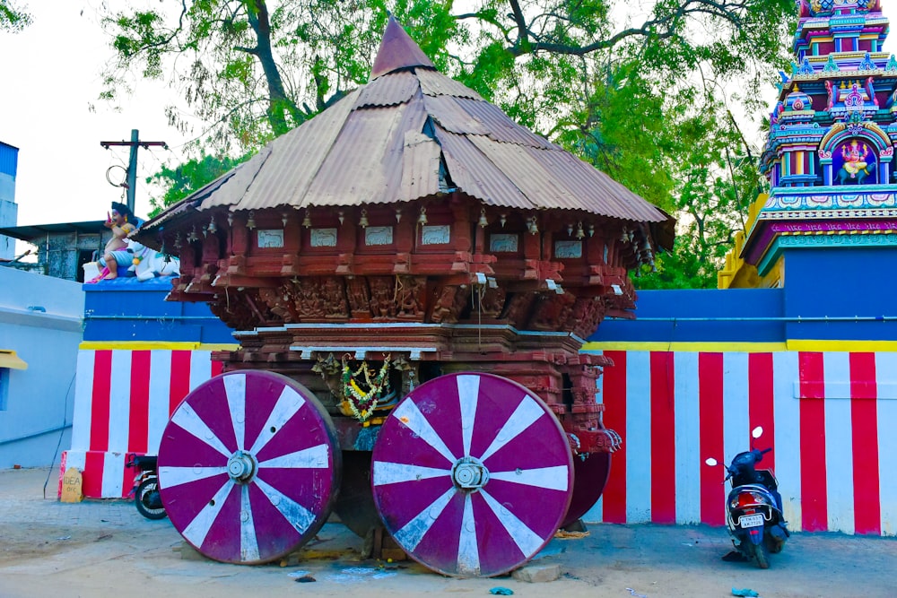 a colorful building with two large wheels in front of it