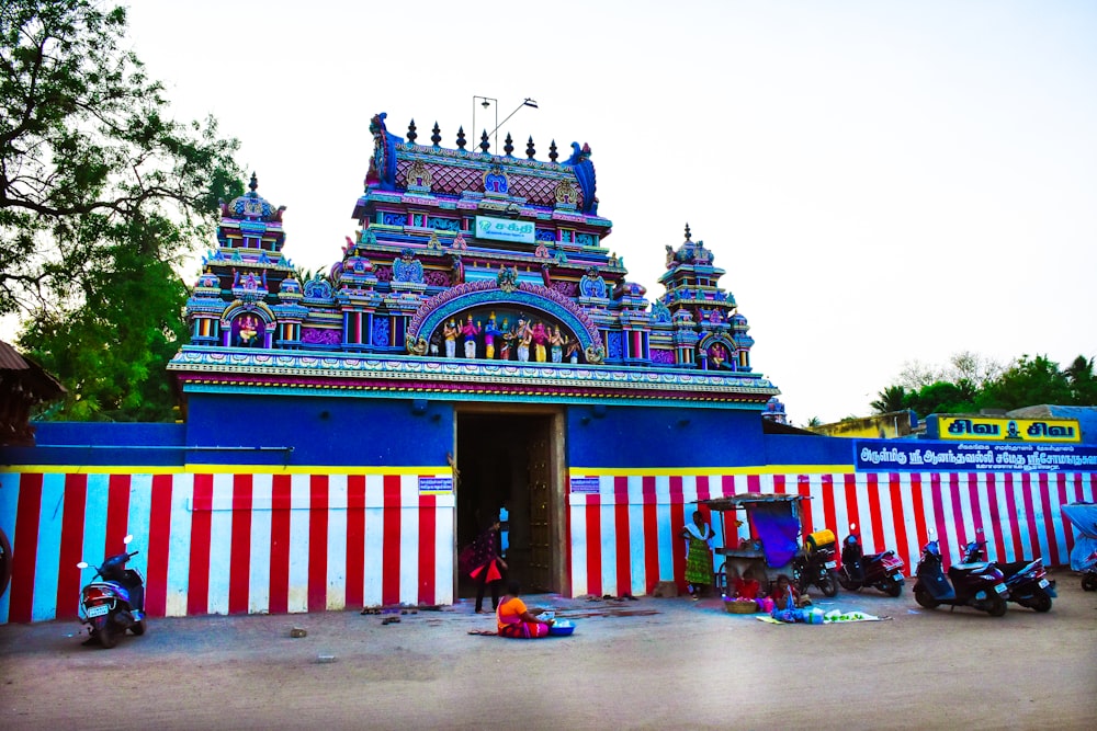 a colorfully painted building with motorcycles parked in front of it