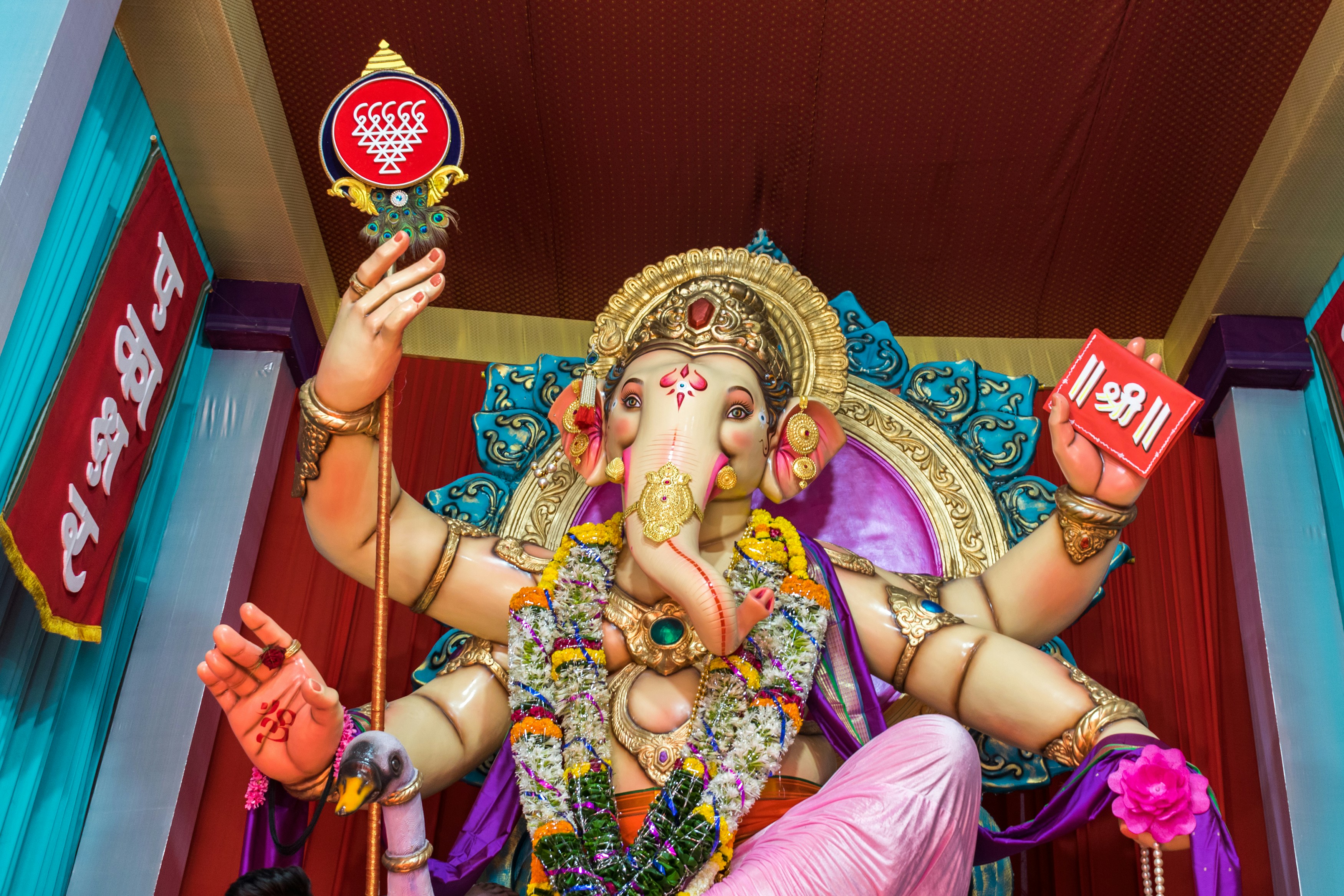 a statue of a god holding a cup