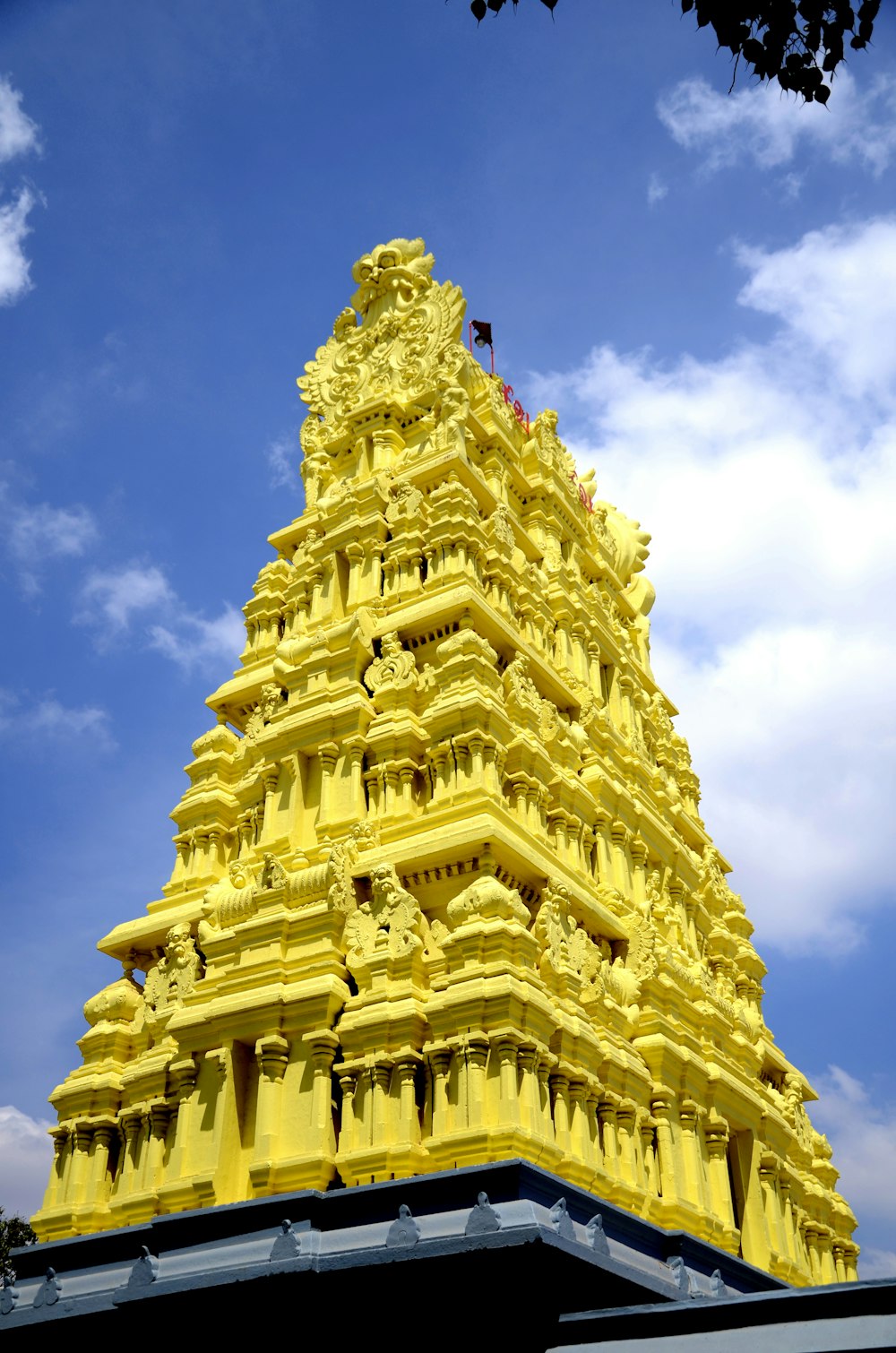 a tall yellow building with a sky background