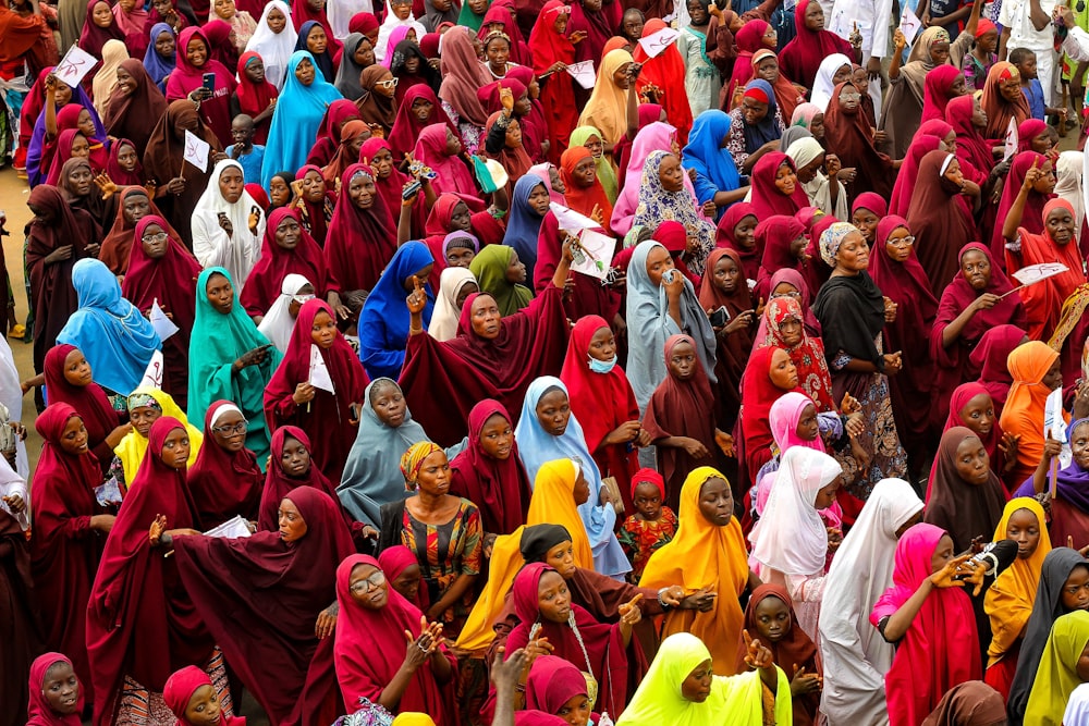 a large group of women in brightly colored outfits