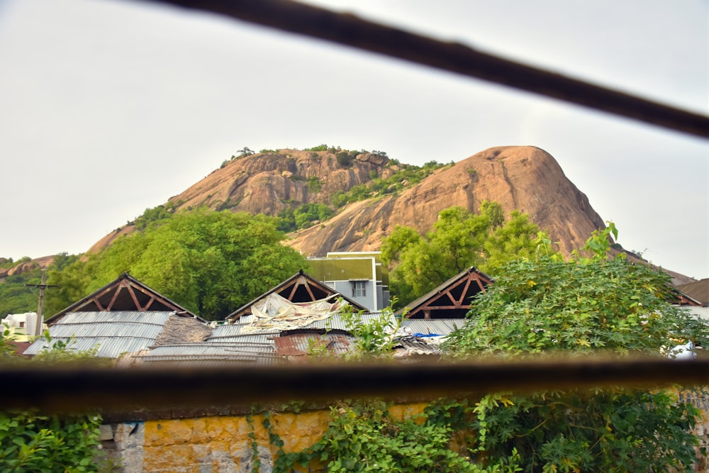 a view of a mountain from behind a fence