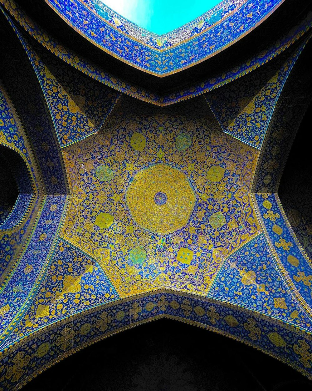 the ceiling of a building with blue and yellow designs