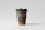 A paper coffee cup with a black lid stands upright against a plain, light gray background. The cup is labeled as a biodegradable paper cup mockup with elegant white text printed on an olive green band around its upper section. The bottom part of the cup shows a natural brown color, typical of kraft paper.