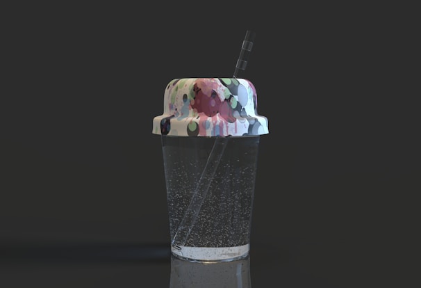 Refreshing soda with ice cubes in a transparent cup with a straw