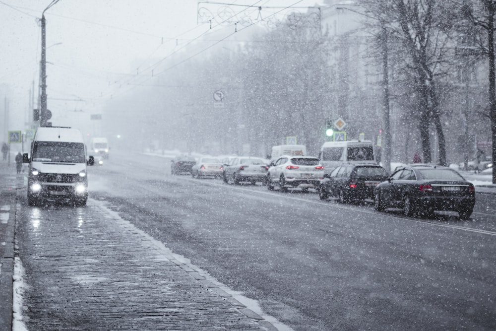 a street filled with lots of traffic on a snowy day