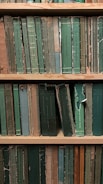 An old library shelf filled with worn books on anthropology and mysticism.