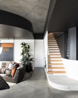 a living room filled with furniture and a staircase