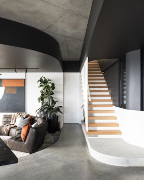 a living room filled with furniture and a staircase