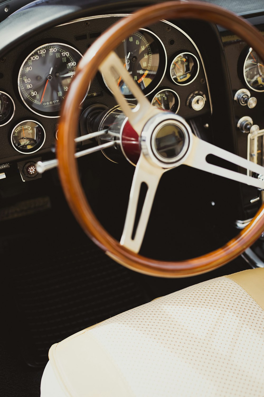 a steering wheel and dashboard of a classic car